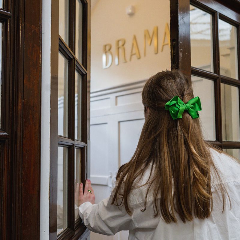 Girl opening door at Brama hotel in south london