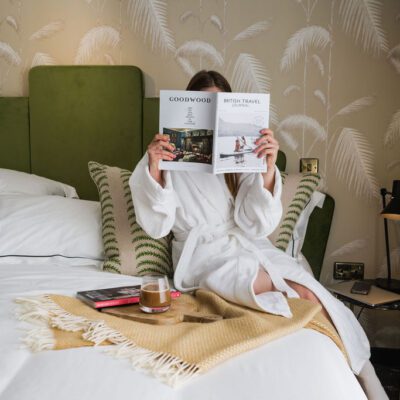 person reading in bed with coffee